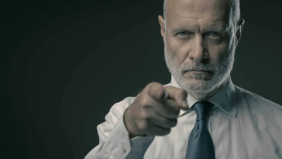 Corporate business executive pointing at camera, selection and recruitment concept