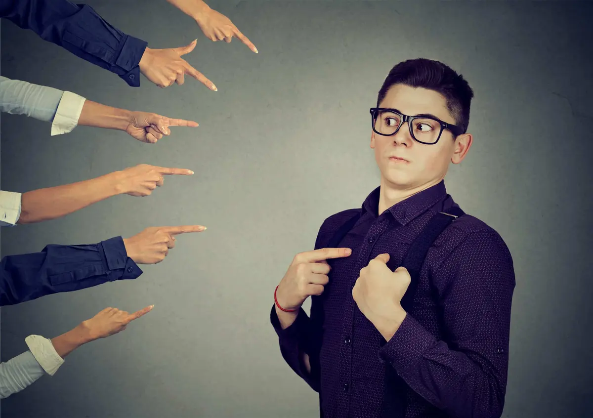 Blaming you. Anxious man judged by different people pointing fingers hands at him. Concept of accusation of guilty guy. Negative human emotions face expression feeling