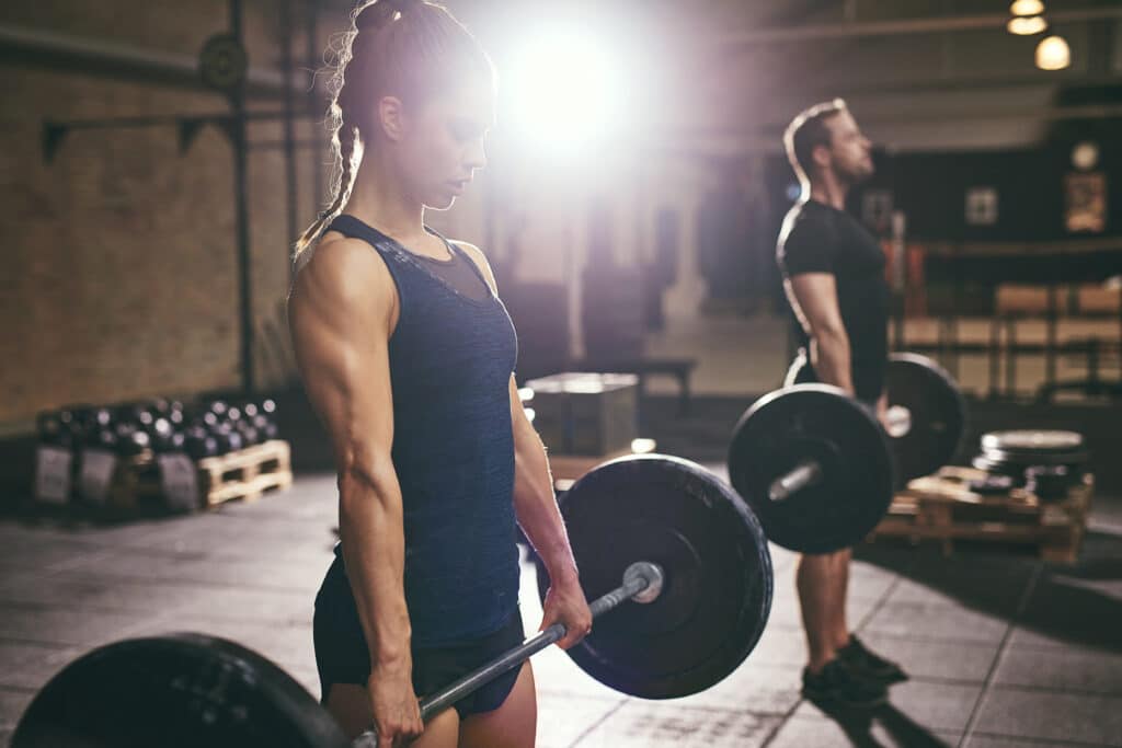 deadlift Man and woman doing deadlift with barbells