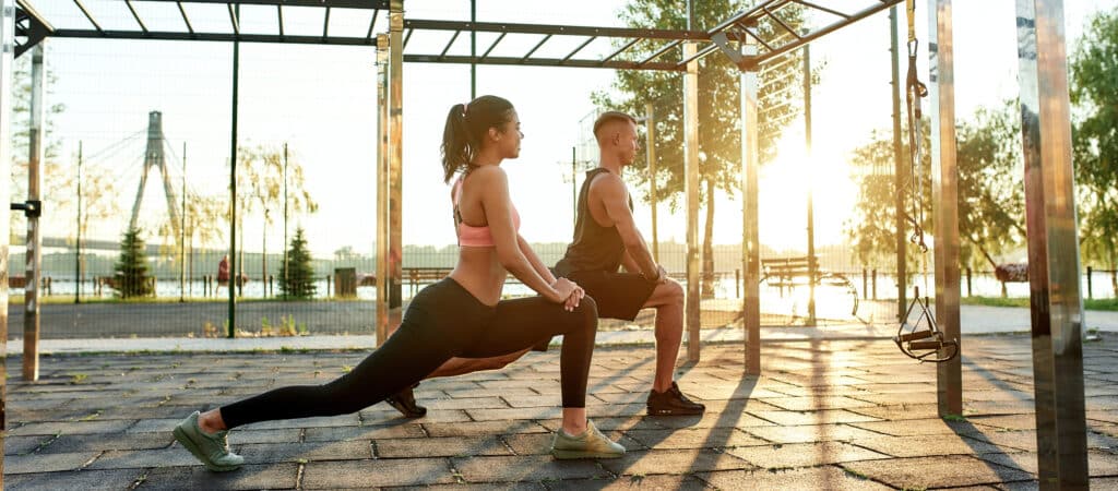 Young mixed race girl and caucasian man doing lunges